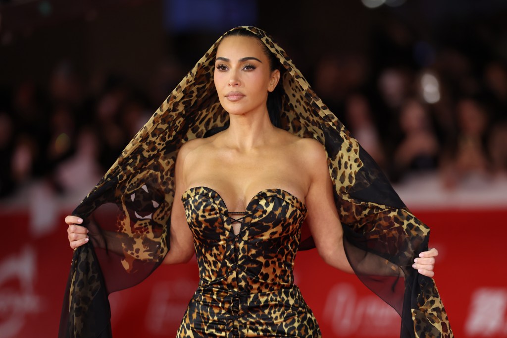 Kim Kardashian attends the "All's Fair" screening during the Rome Film Festival wearing a leopard-print dress and matching head covering.
