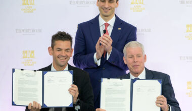 NASA Administrator Jared Isaacman, seated left, and U.S. Secretary of Energy Chris Wright, seated right, hold the signed Memorandum of Understanding, “Accelerating American Leadership in Space Nuclear Power and Propulsion”, as Director of the White House Office of Science and Technology Policy (OSTP) Michael Kratsios, looks on, during the Golden Age Summit, Thursday, Oct. 8, 2026, at the Donald J. Trump Institute of Peace in Washington.