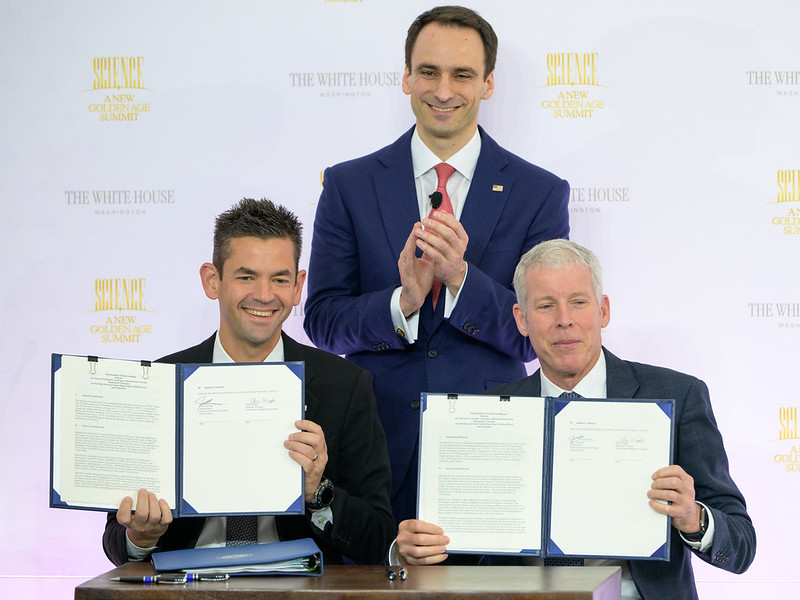 NASA Administrator Jared Isaacman, seated left, and U.S. Secretary of Energy Chris Wright, seated right, hold the signed Memorandum of Understanding, “Accelerating American Leadership in Space Nuclear Power and Propulsion”, as Director of the White House Office of Science and Technology Policy (OSTP) Michael Kratsios, looks on, during the Golden Age Summit, Thursday, Oct. 8, 2026, at the Donald J. Trump Institute of Peace in Washington.