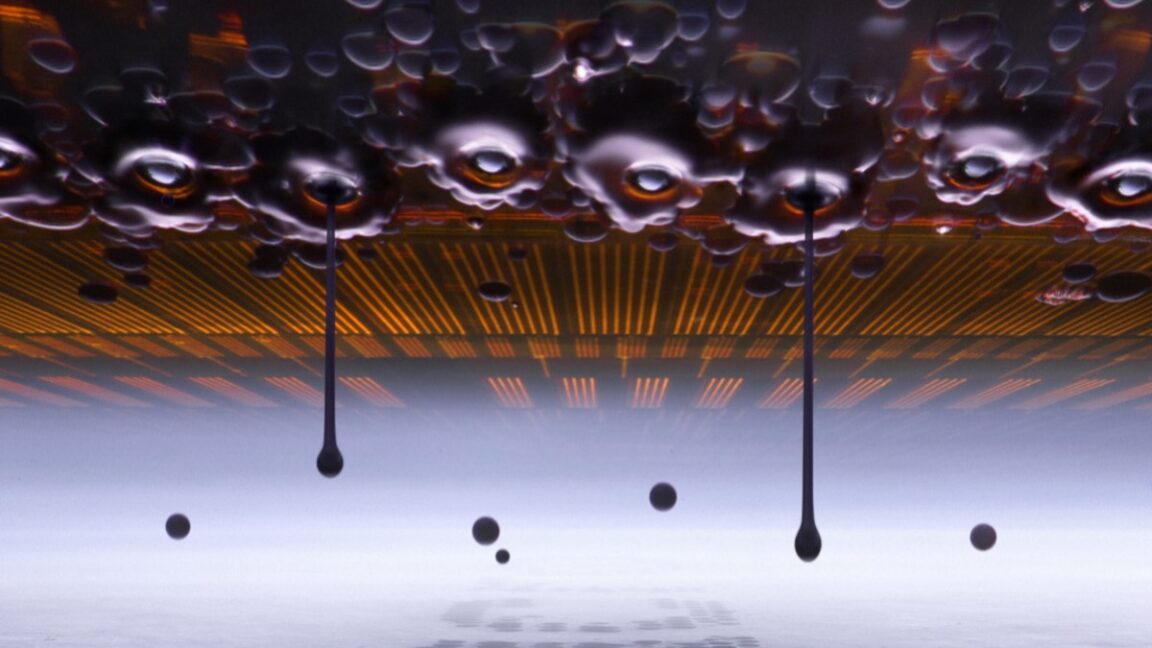 microscopic view of an inkjet printer depositing ink onto paper