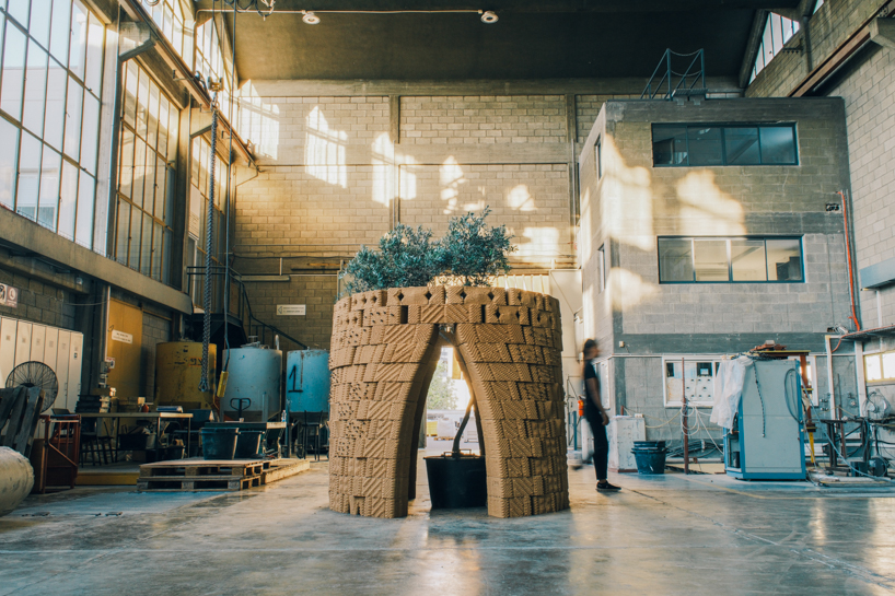 robotically 3d printed earth bricks wrap a multispecies habitat around an olive tree 1