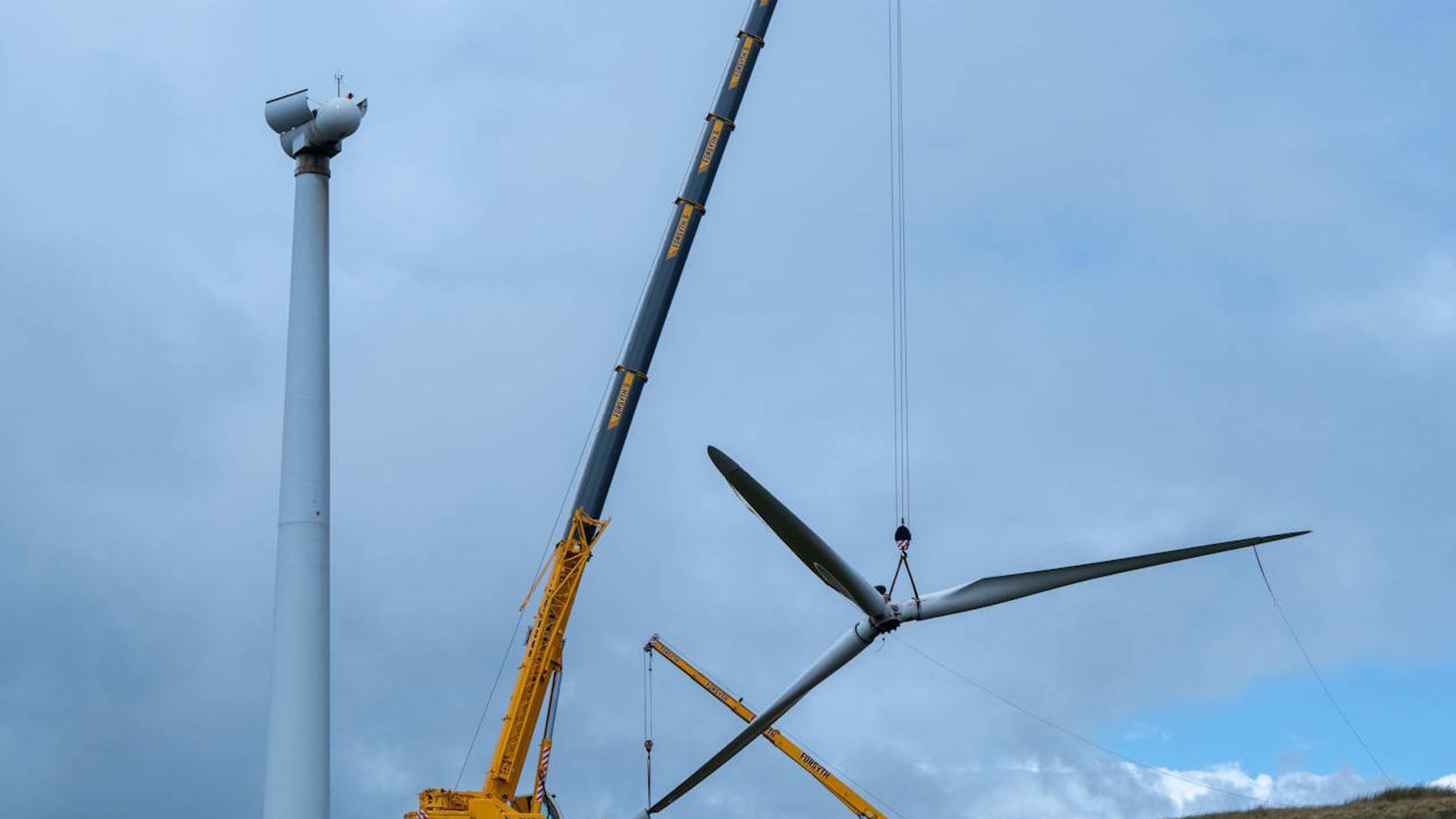 Crane lowering a sawn turbine blade at a Scottish wind farm turbines recycled site, scotland s first