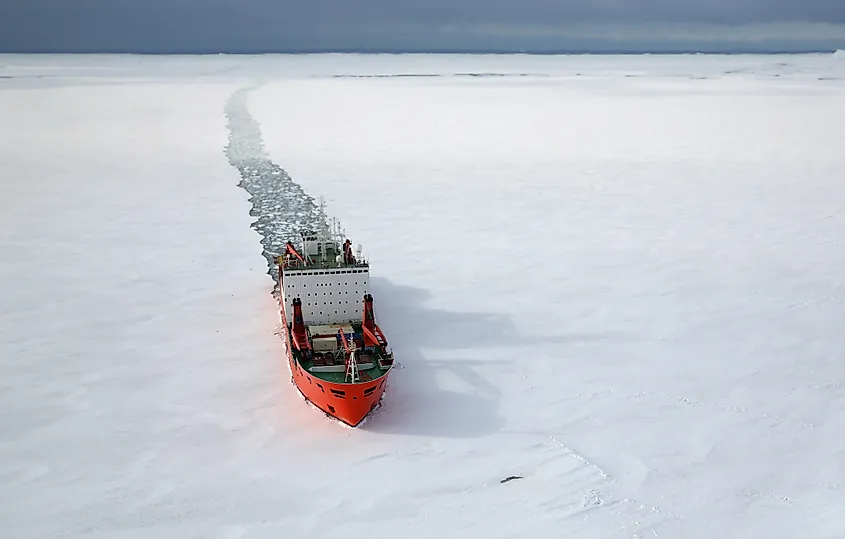 A research vessel pushing through pack ice in the Southern Ocean.