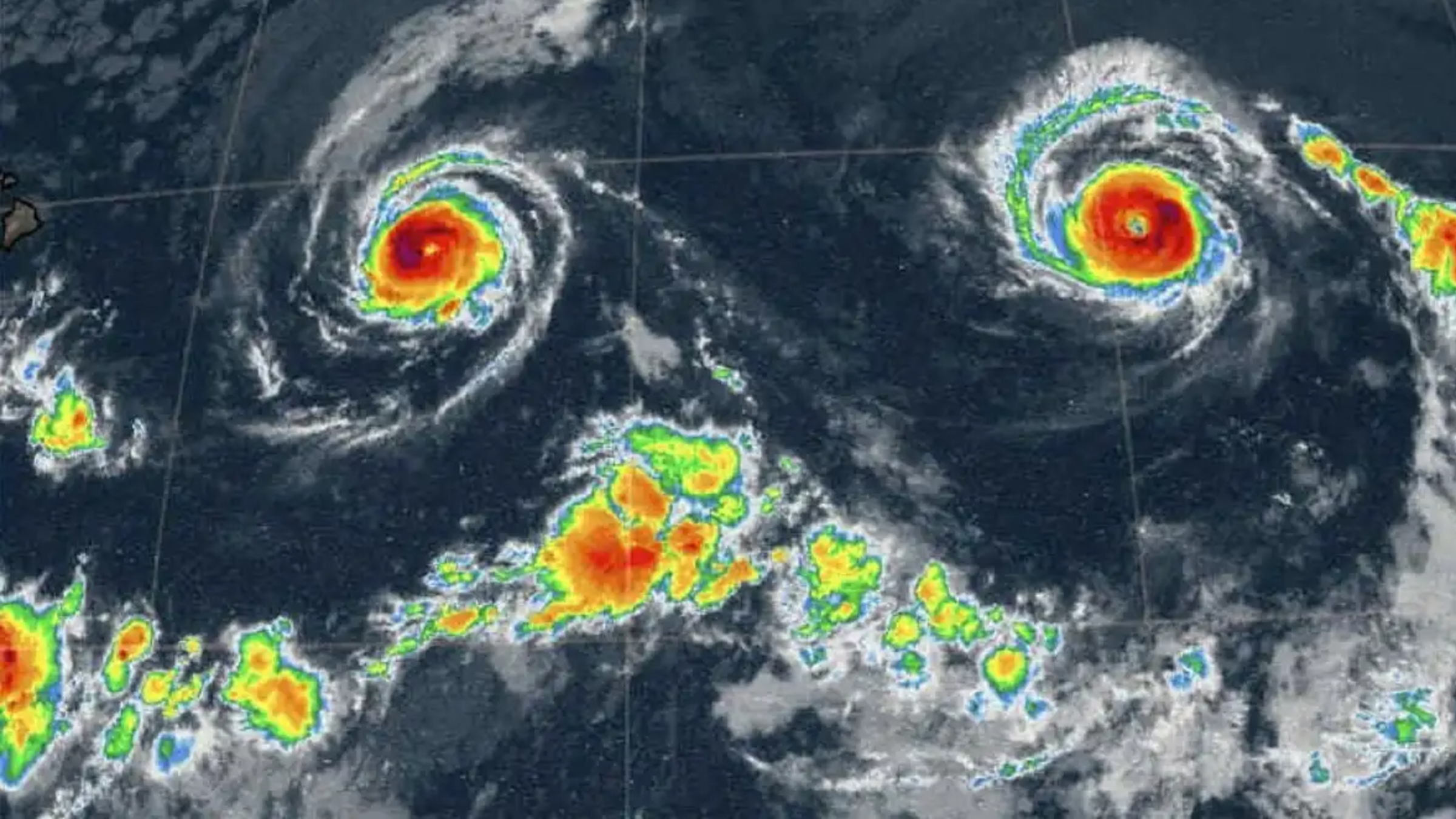 A radar weather map showing two hurricanes that look like the eyes in a multicolor smiley face