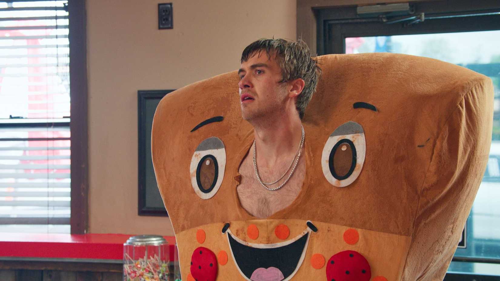 Luke Burke in a pizza costume in Minimum Wage