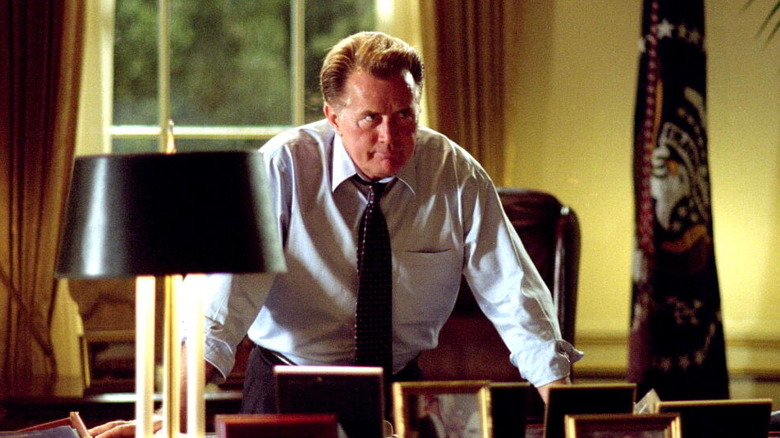 Martin Sheen as Jed Bartlet, leaning over his desk in The West Wing.