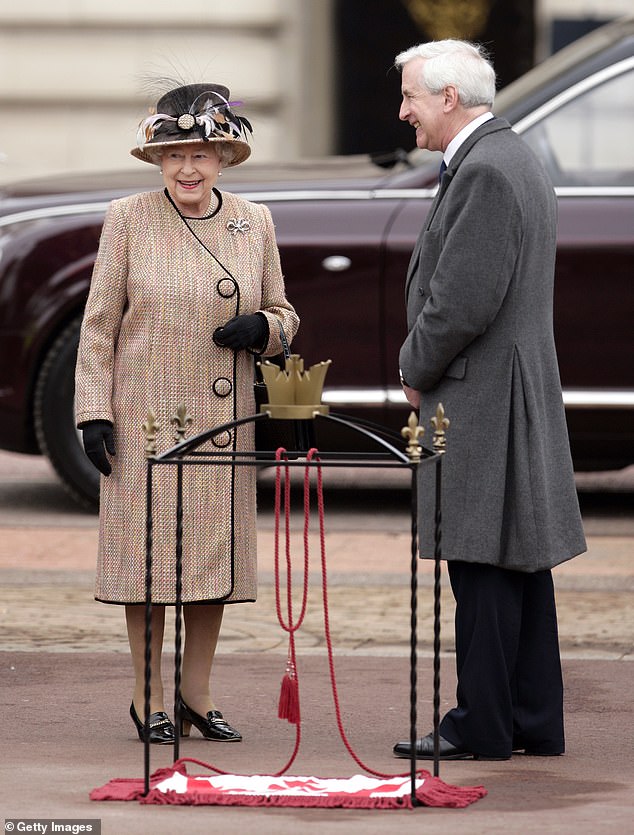 Queen Elizabeth II talks with Hugo Vickers outside of Buckingham Palace in 2012