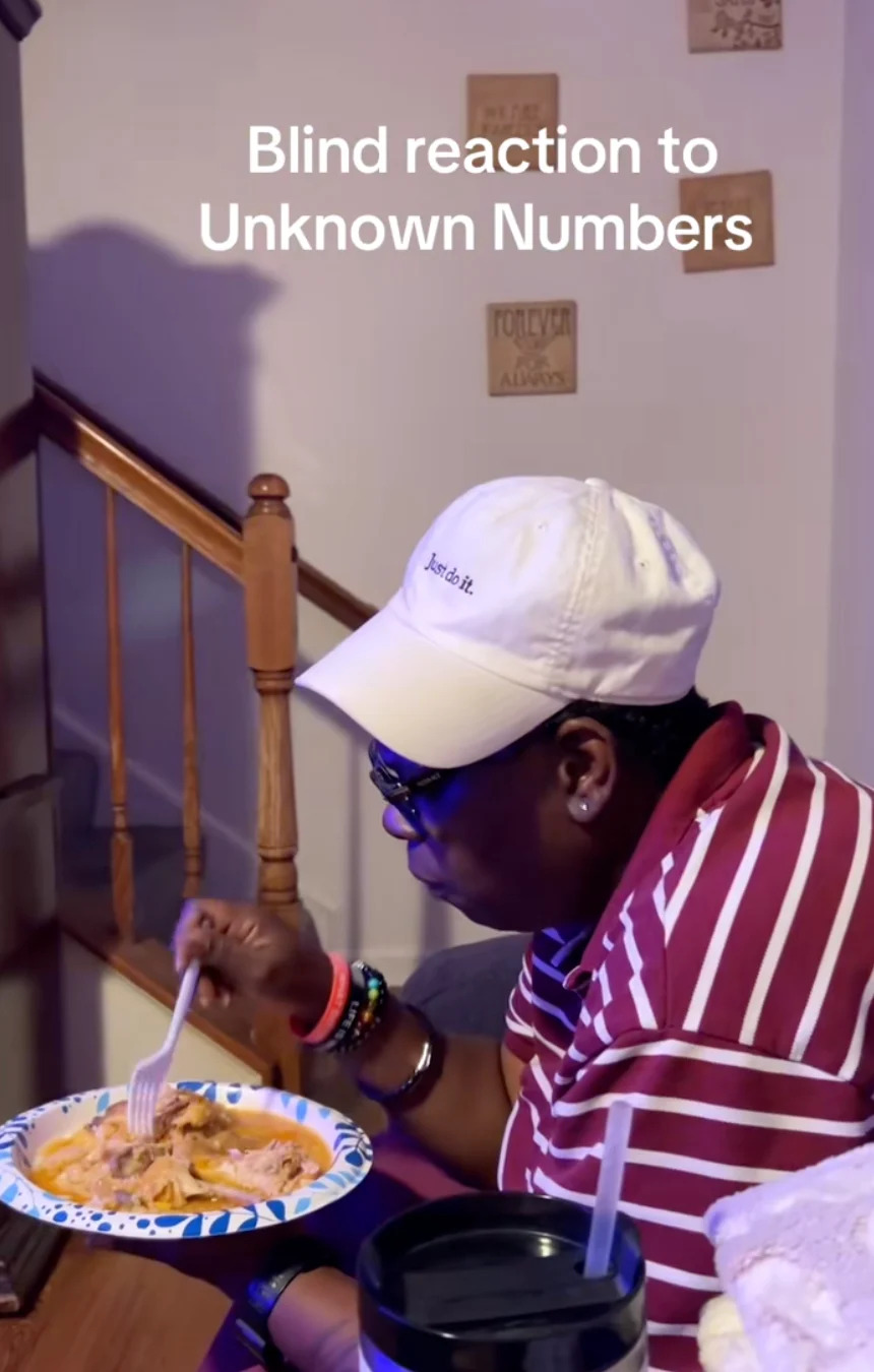 Person in a striped shirt and cap eats from a paper plate, text reads "Blind reaction to Unknown Numbers."