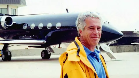 US Department of Justice/PA Jeffrey Epstein standing in front of his private plane