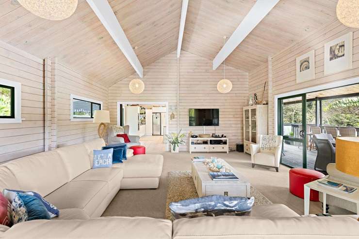 A five-bedroom bach at 3 Elizabeth Point Road is one of Kawau Island's flashiest homes and comes with access to a helipad. Photo / Supplied