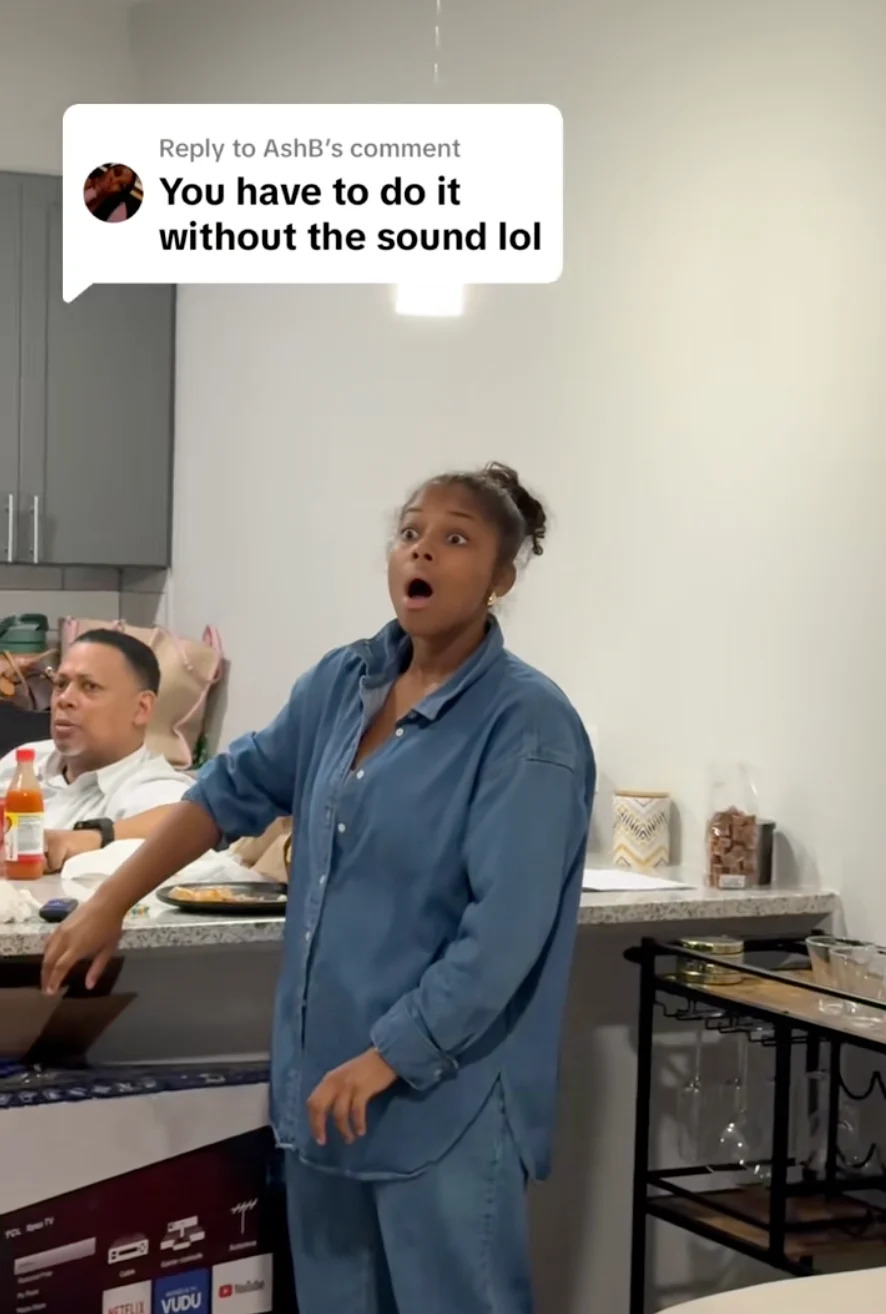 Person in a casual outfit appears surprised while opening a box in a kitchen. Comment reads: "You have to do it without the sound lol."