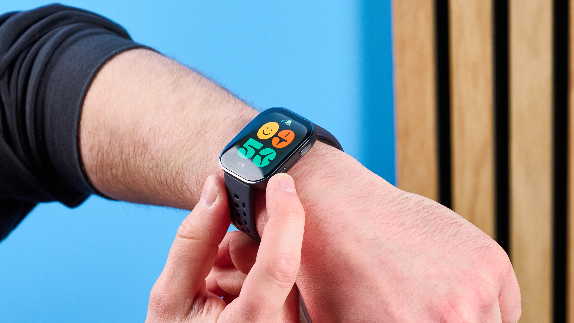 The Amazfit Bip 6 smartwatch photographed in front of a blue background