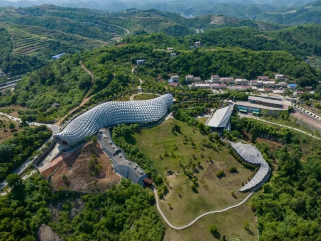 Aerial view of a lush green region with buildings