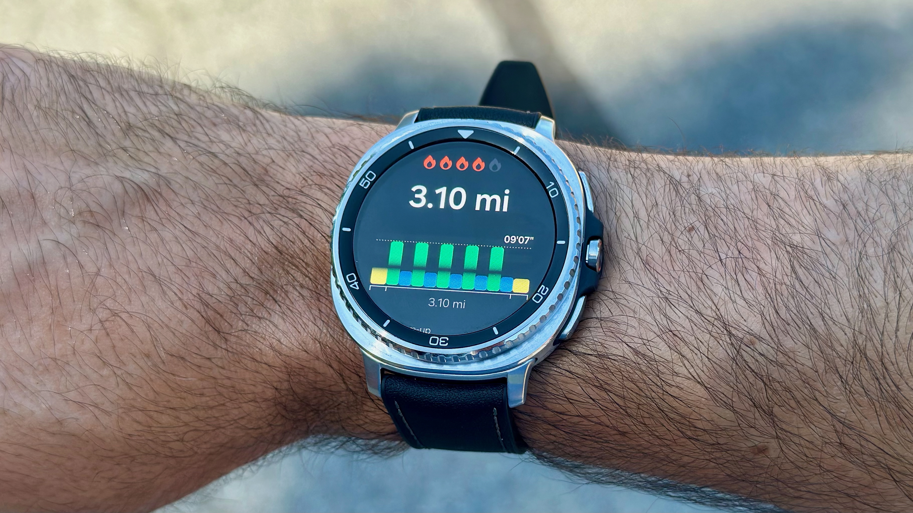 The Samsung Galaxy Watch 8 Classic showing a Running Coach workout, with a distance of 3.1 miles and a target pace of 9:07.