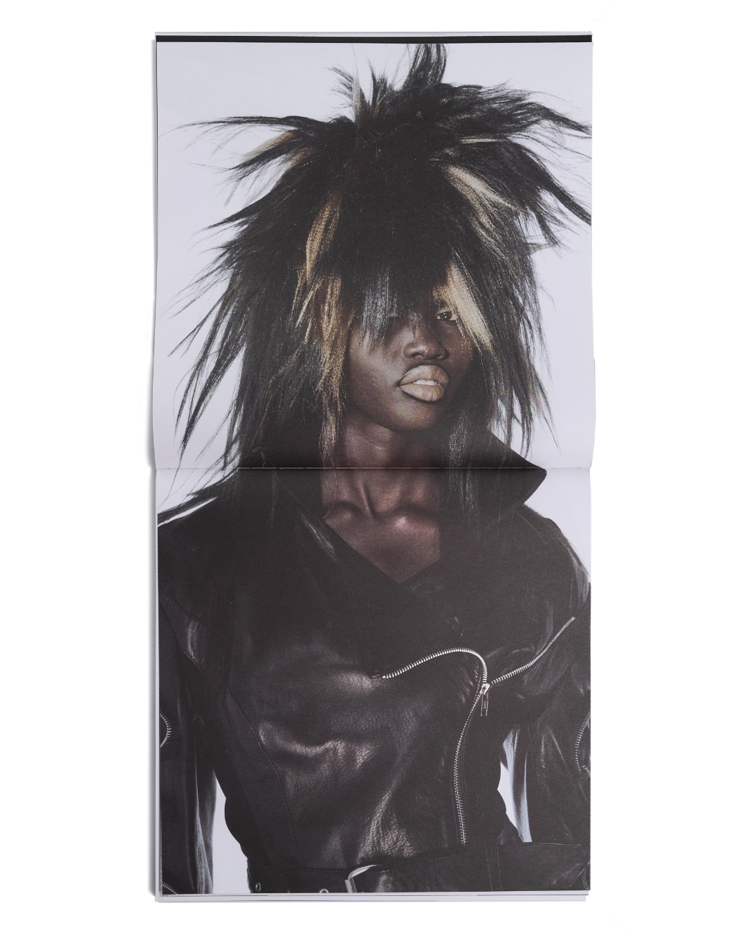 Woman wearing a black leather jacket with a glam rock hairstyle