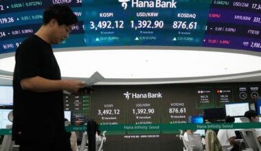Asian shares trade mixed after US stocks set more records