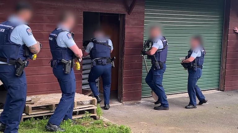 Armed police during a raid of one of the properties.