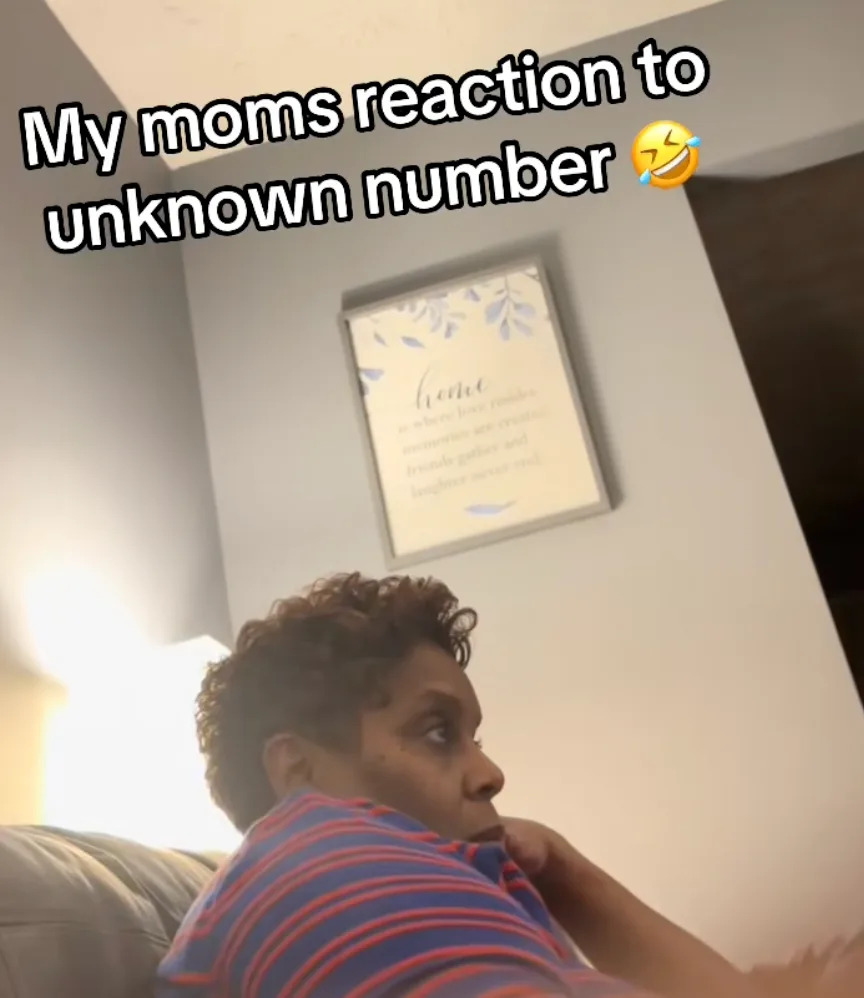 Woman sitting on a couch, looking concerned. Wall art reads: "home is where you are loved." Text says, "My mom's reaction to unknown number."