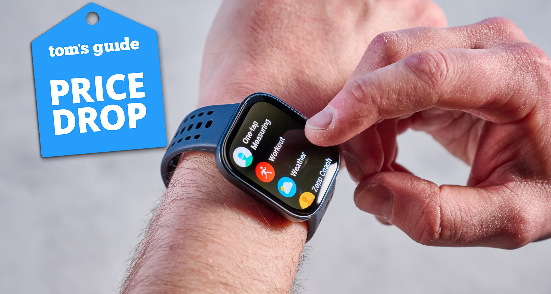 Amazfit Bip 6 on a man's arm on a grey background with a blue price drop tag.