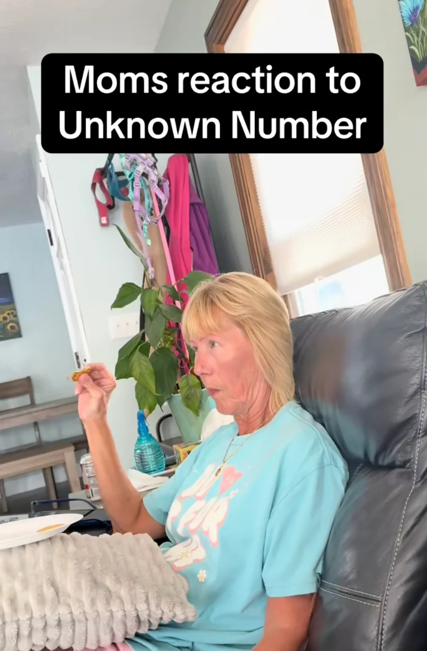 Woman sitting on a chair, reacting to a phone call from an unknown number; caption included