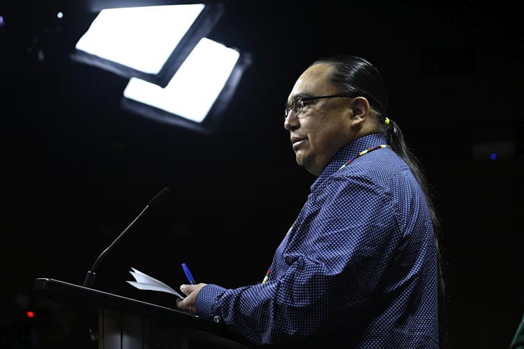 A man speaking at a podium.