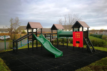 Playground with ground covering made from recycled materials