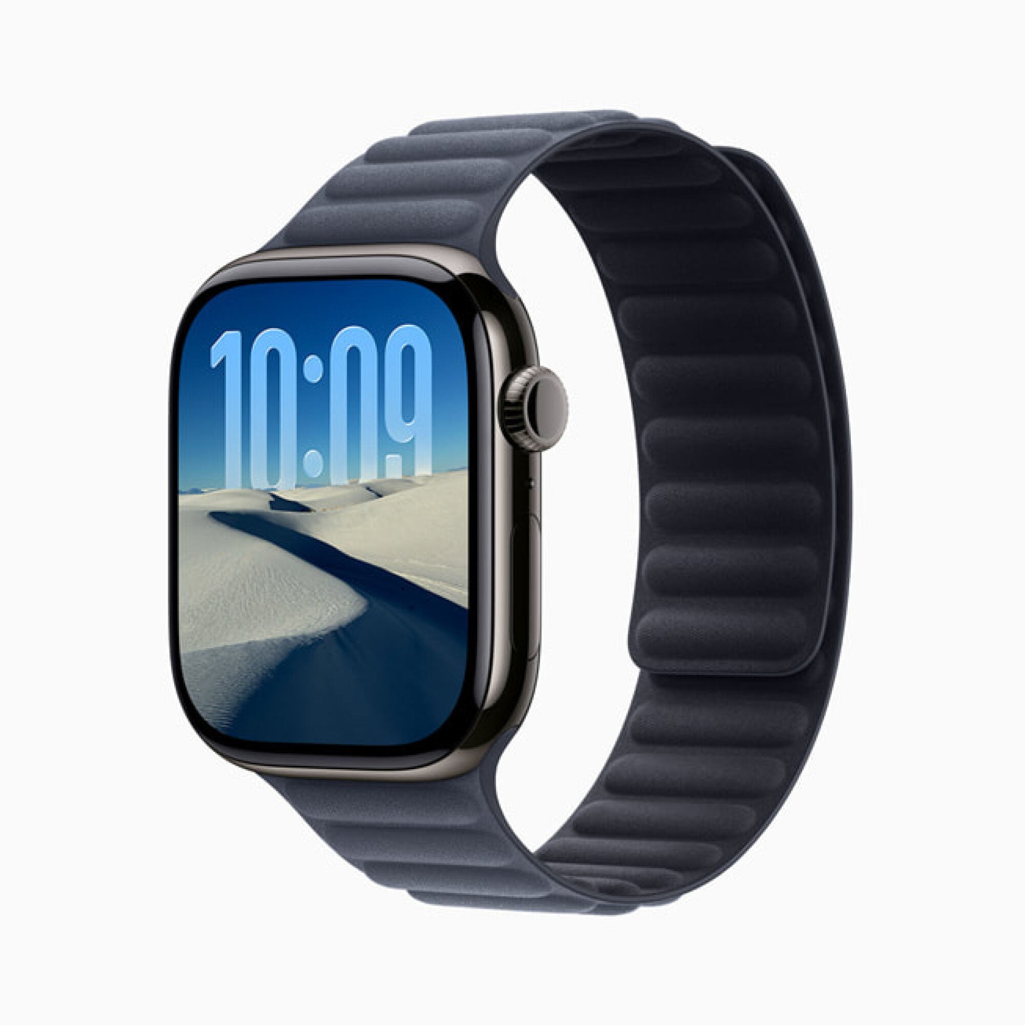 An Apple watch displaying a desert scene and blue sky, with the current time incorporated into the landscape.