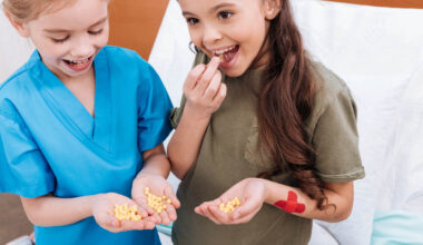 A couple of kids chowing down on some little pills
