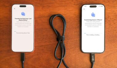 Two iPhones connected by a cable.