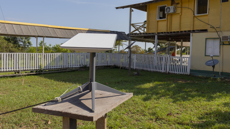 A Starlink satellite internet dish providing broadband connection on an Amazon rainforest rural property.