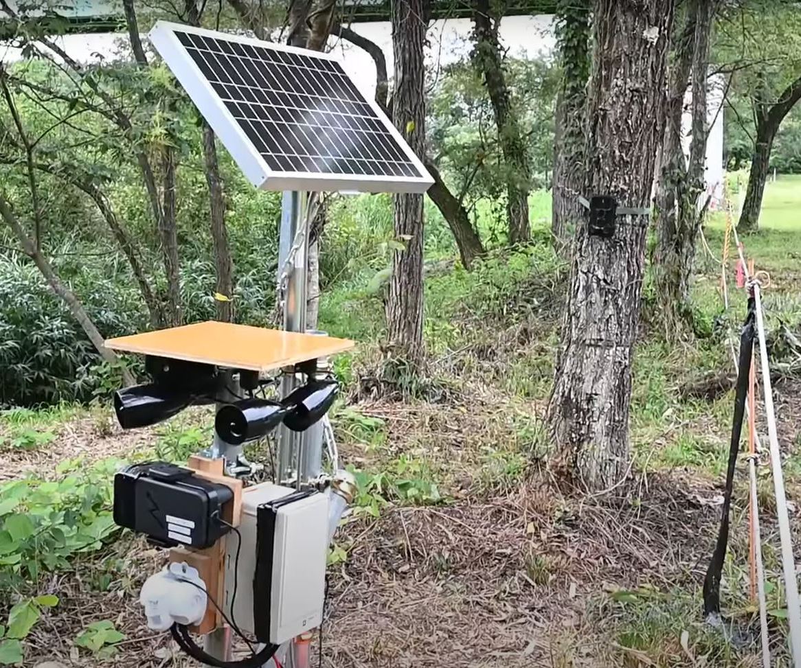 An acoustic device with a solar panel for deterring bears in Fukushima.