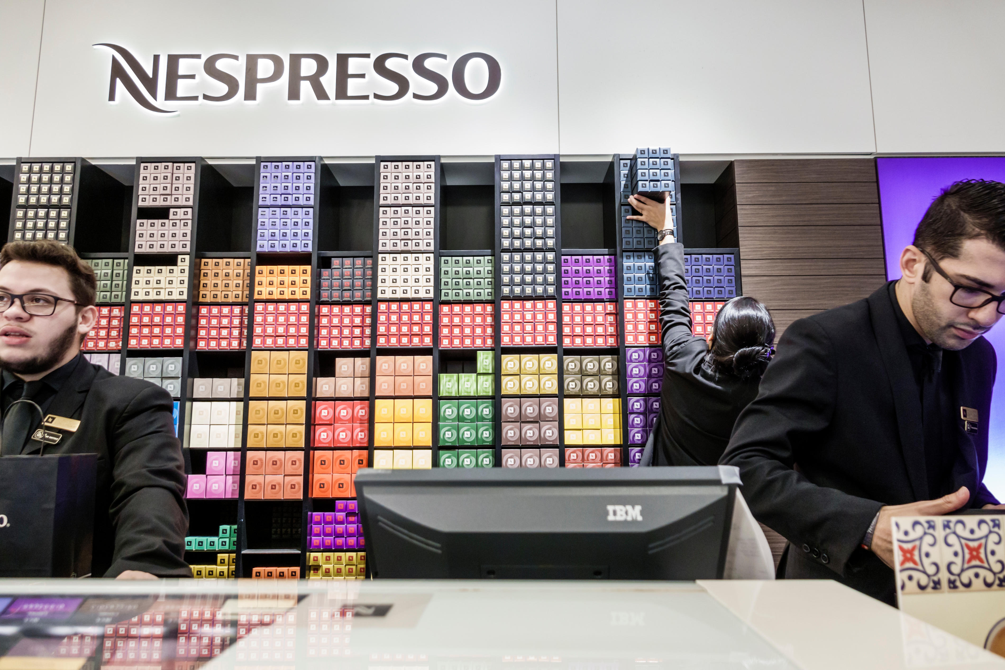 Nespresso employees at a counter in Dadeland Mall, Miami, Florida.