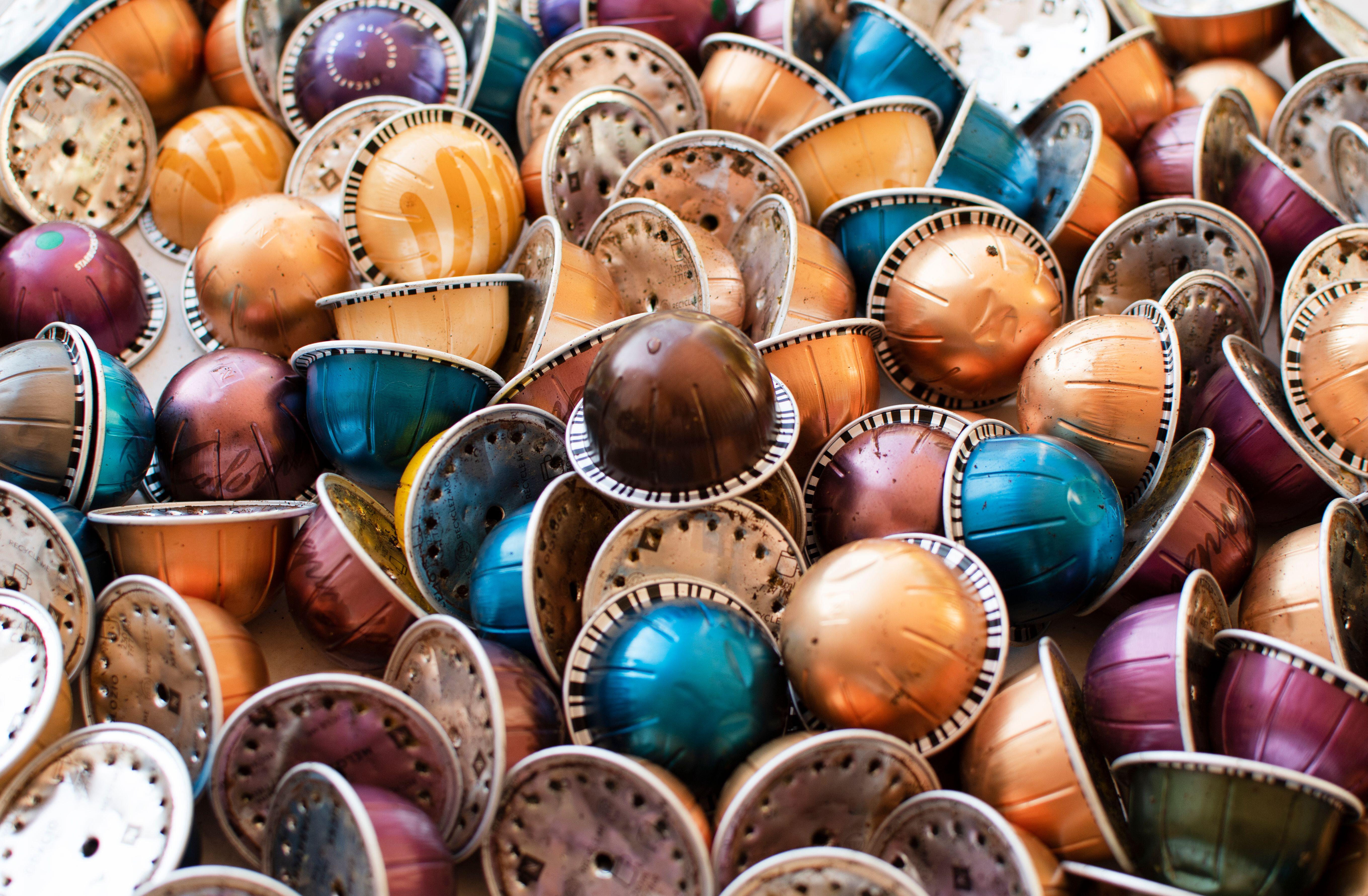 Hundreds of used, multi-colored coffee pods.