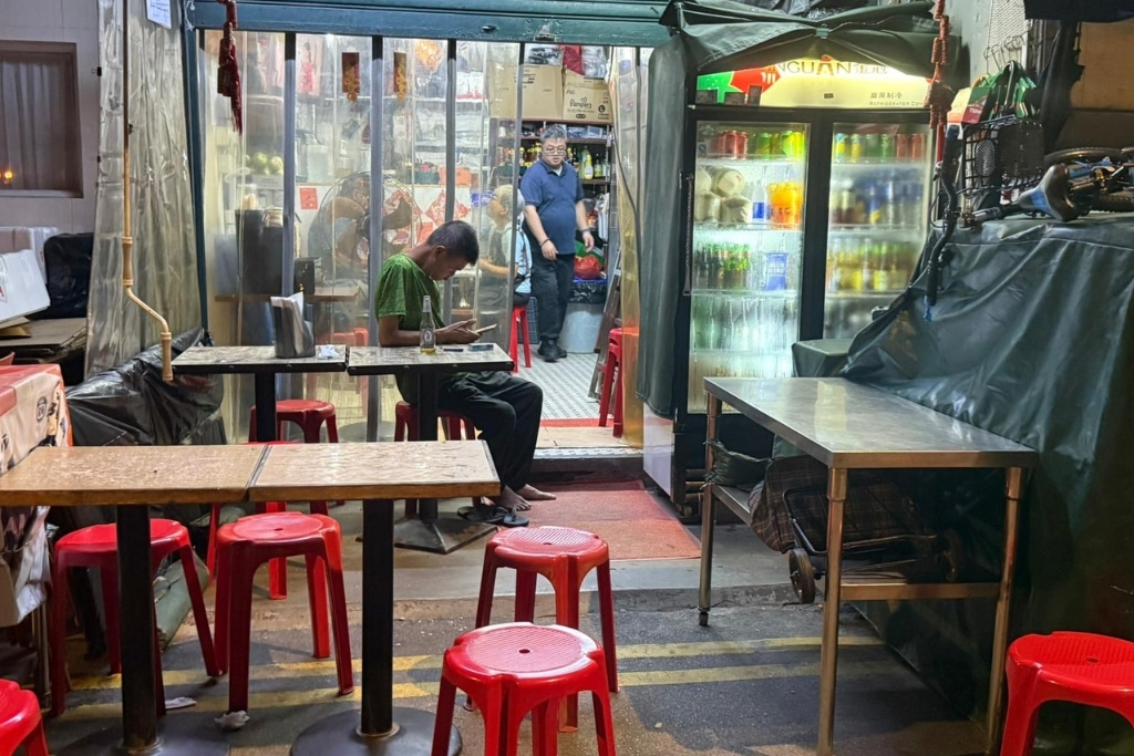 Nighttime temperatures in Hong Kong are still high in autumn with people leaving their hot homes after dark to have a cold drink in cooler outside air.