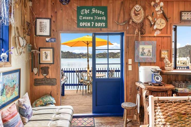 The two-bedroom historic bach at 104 Okura Bay Road, in Totara North, sits over the water on the edge of Whangaroa Harbour. Photo / Supplied