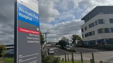 A 15 foot tall sign at the main entrance to Wexham Park Hospital shows people where they should go and where they should park when coming to an appointment