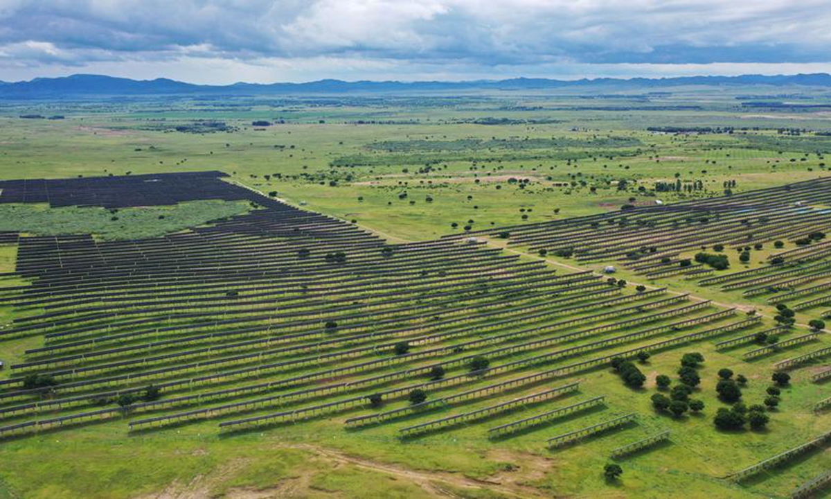 An aerial drone photo taken on July 29, 2025 shows photovoltaic panels at the site of a desertification control project integrated with wind and solar power facilities in Horqin Right Wing Middle Banner of Hinggan League, north China