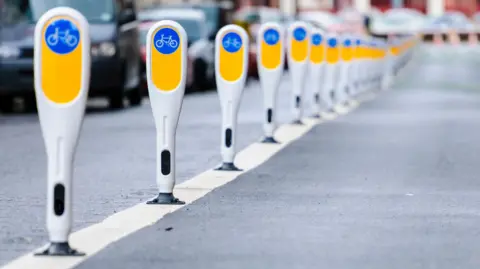 Getty Images Row of bollards separating a cycle lane from motor vehicles.