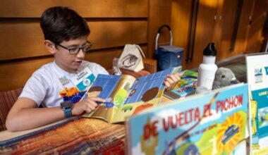 Luke Szapiel, 9, author of "Back to the Pigeon," displays his book at the Latin American Book Fair at the Kimmel Center on Saturday.