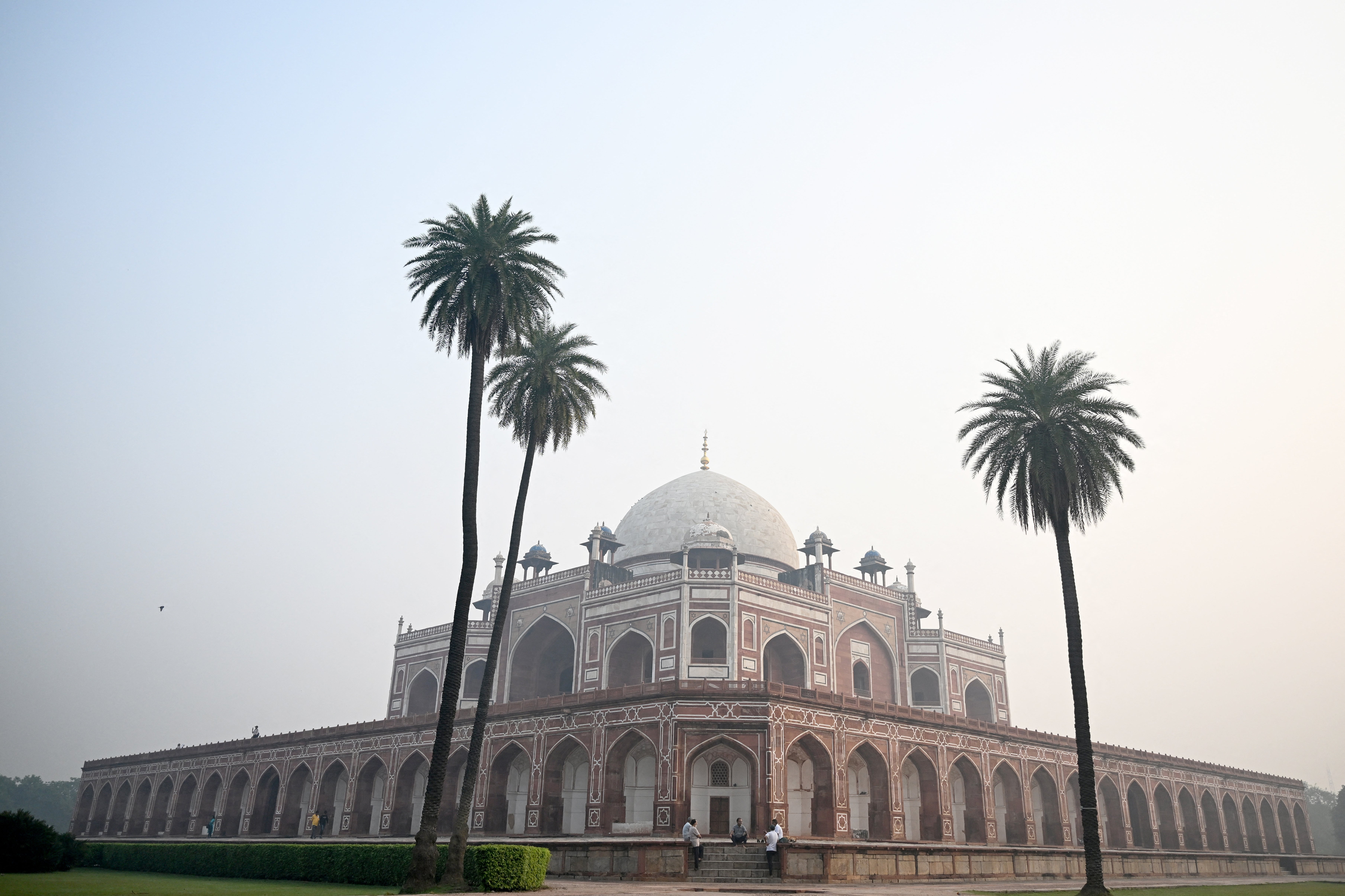 Tourists visit the Mughal monument of Humayun's Tomb as thick smog engulfs Delhi