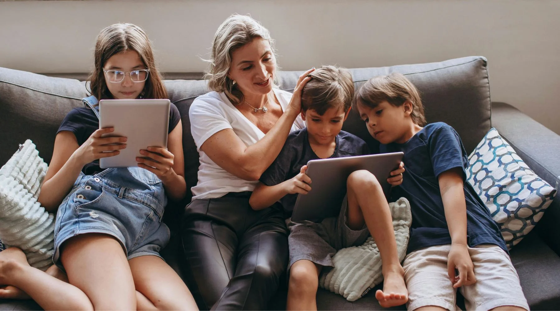 Grandmother_With_Kids_On_Devices_Canva_1800x1000 (1)