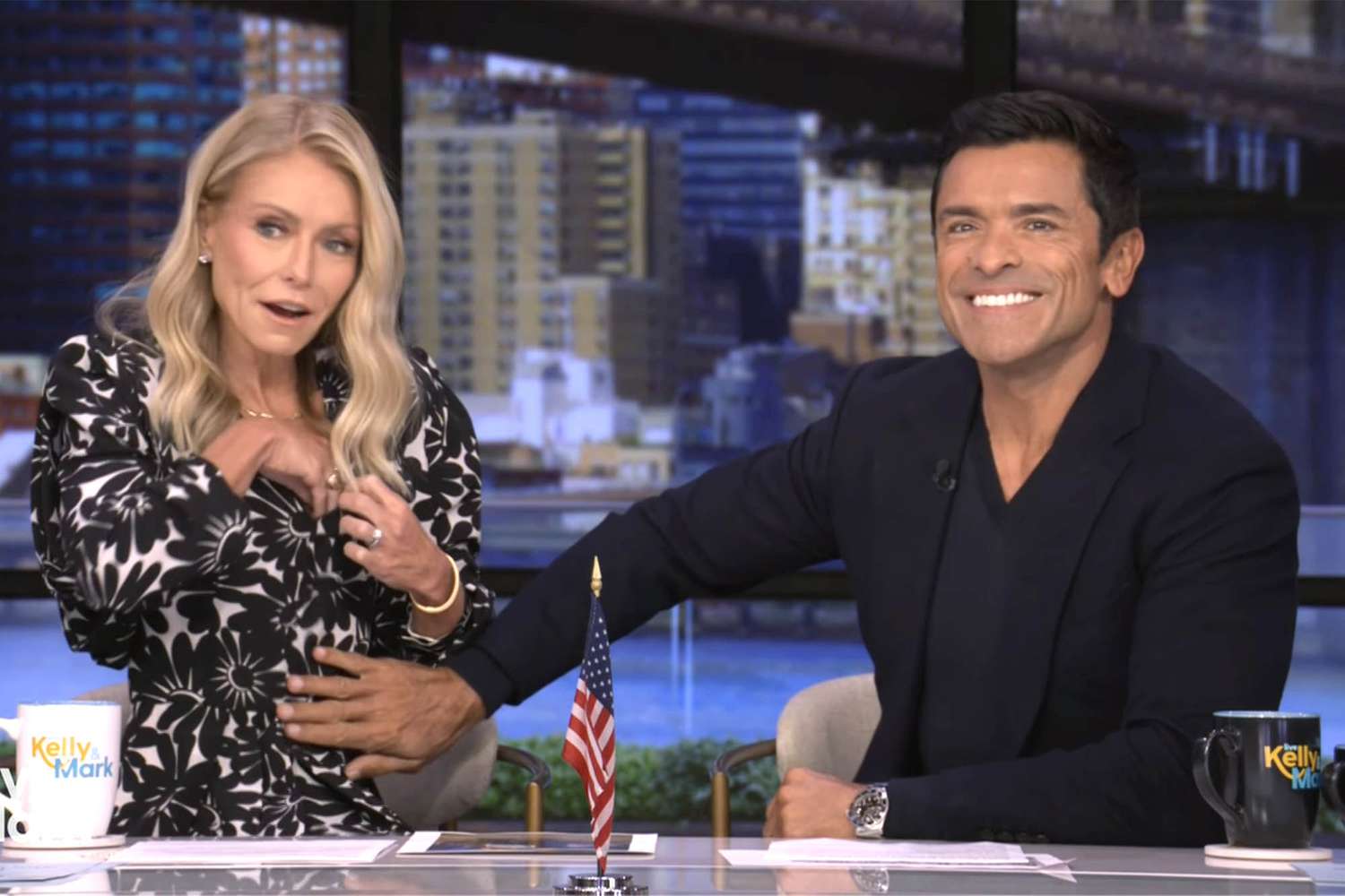 Mark Consuelos reaches over, rubs Kelly Ripa's torso after mic falls 'deep into the cleavage'