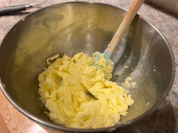 Butter and sugar mixed together with a rubber spatula.