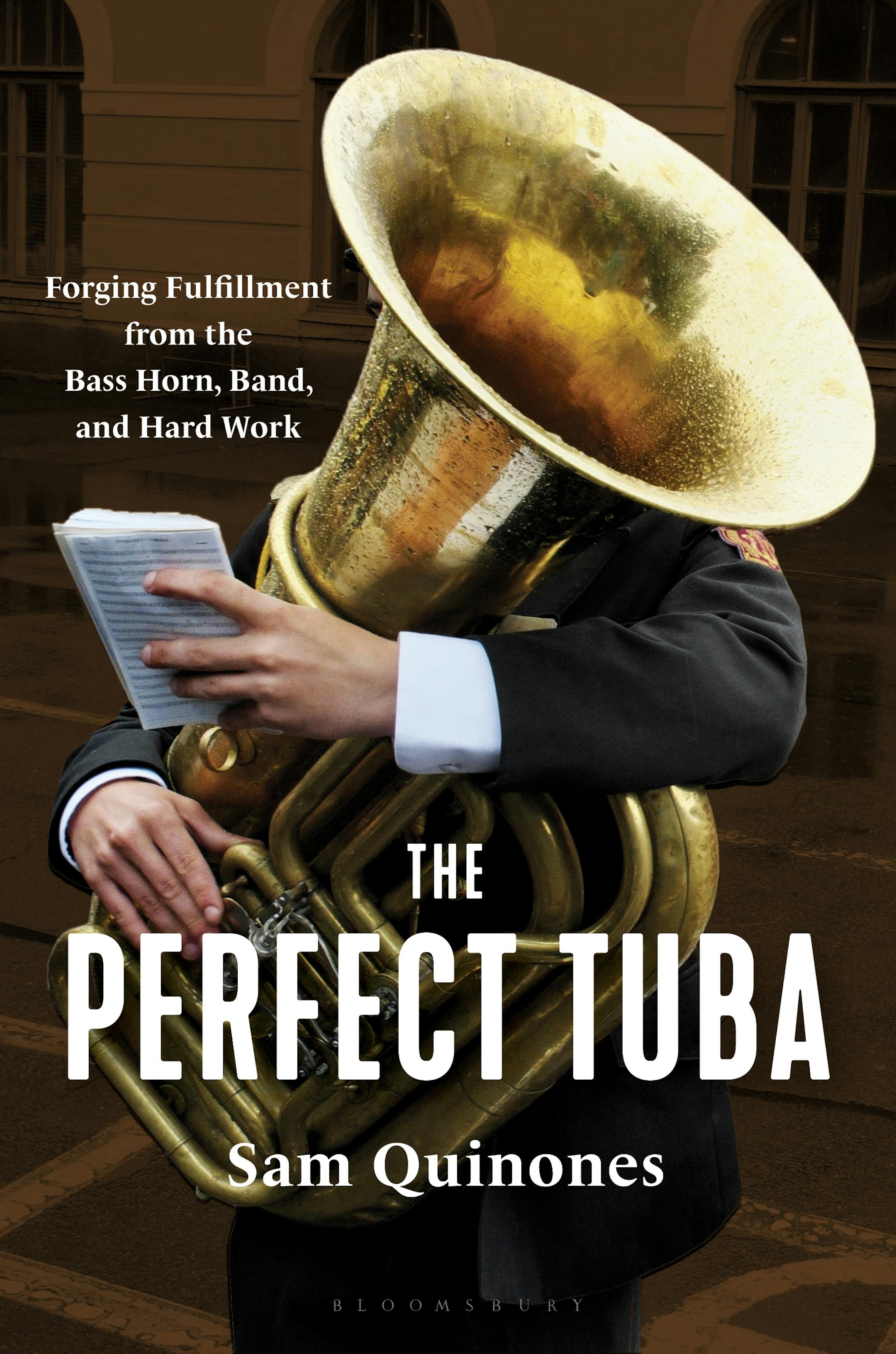 cover of The Perfect Tuba is a photo of a person in a suit, their face obscured, who is playing a tuba while holding a book of sheet musc