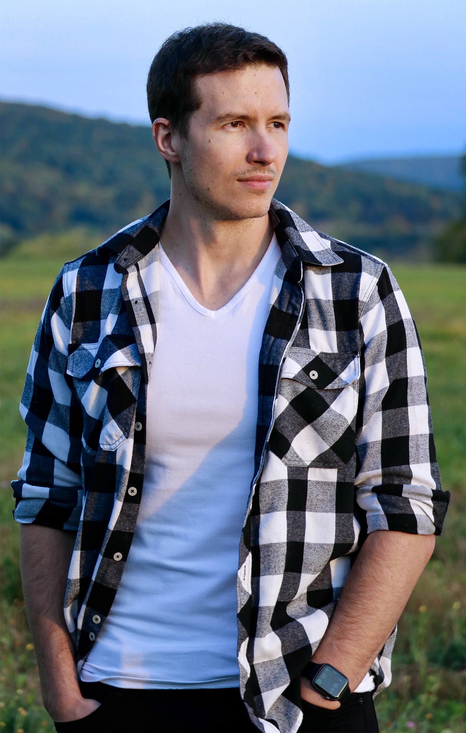 Young man standing outside.