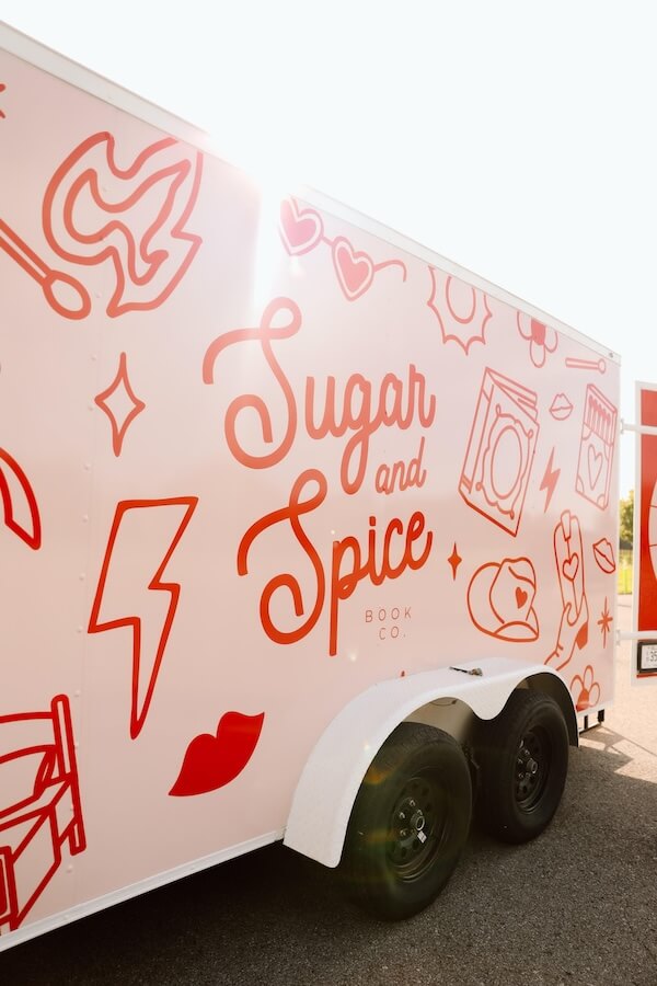 She's Behind Nashville's Sugar and Spice Book Co. - 2 A food trailer with "Sugar and Spice Book Co." written in large red letters and decorated with various red line art illustrations—an inviting spot inspired by Christina Duran’s creative flair.