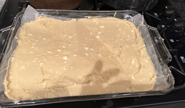 Cake batter showing little pats of butter unmixed
