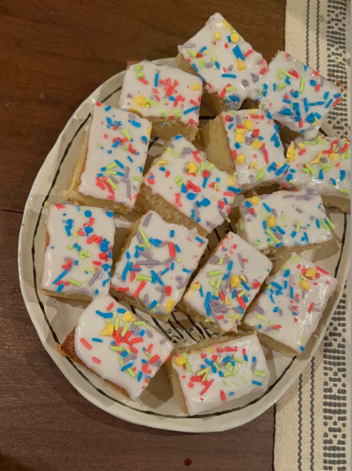 14 school cakes with colorful sprinkles on a plate