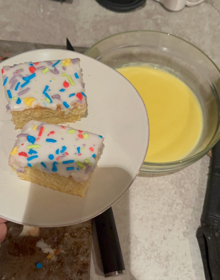 Two slices of school cake pictured with custard