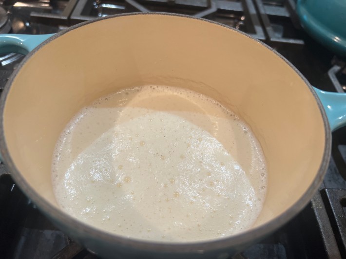 Milk simmering in a saucepan.